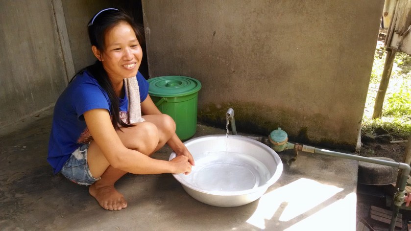 A woman living in Nghia Tho village in Quang Ngai Provence shows me the water that now flows into her house thanks to the well. (Photo by Nissa Rhee, June 2014)