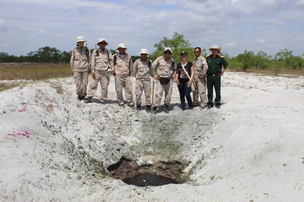 The EOD team and I stand behind the crater that formed from one of the detonations. (Photo by Nguyen Thanh Phu, June 2014)