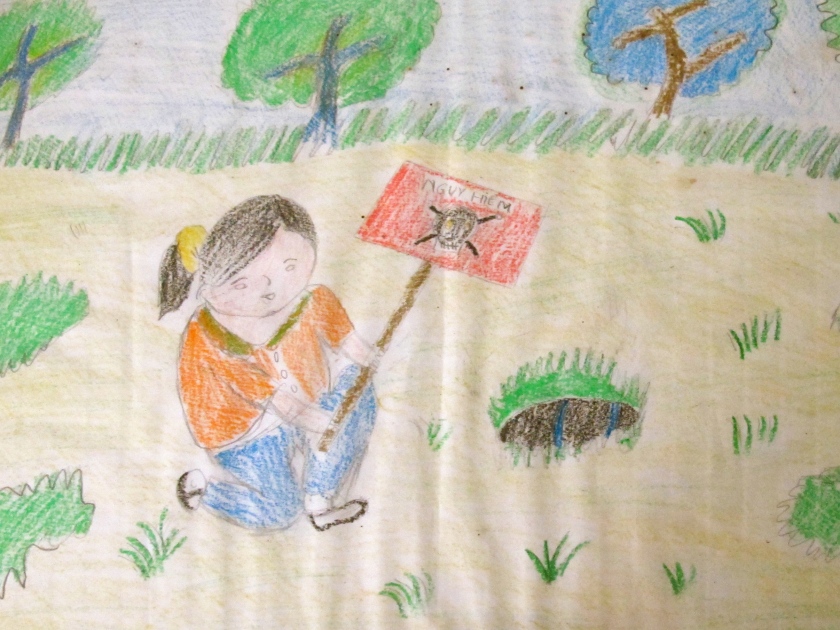A child's drawing shows the discovery of UXO in a field. Students who come to Project Renew's Visitor Center are asked to draw something that they learned on their field trip. (Photo by Nissa Rhee, June 2014)