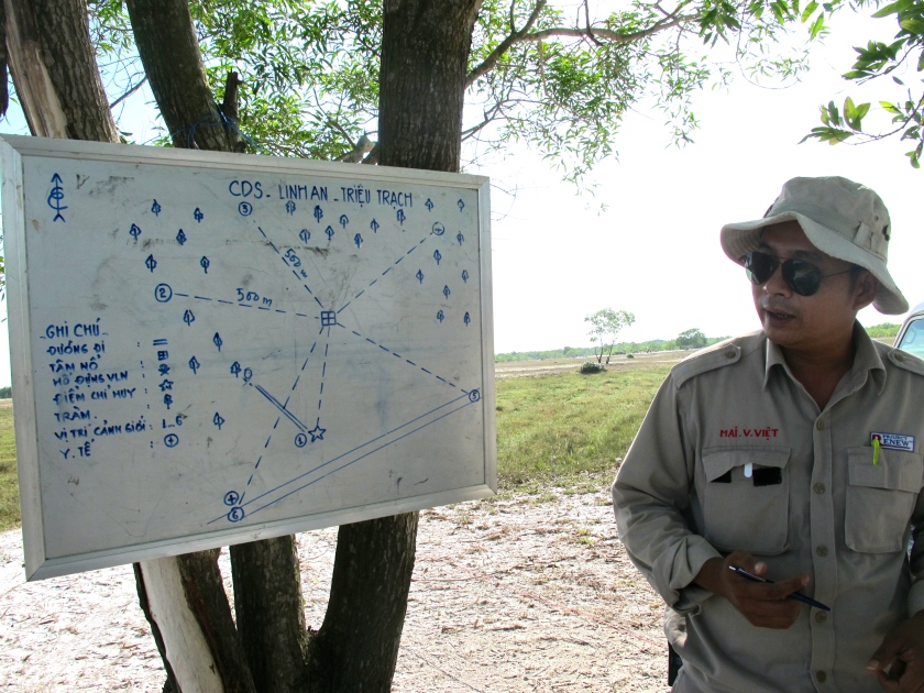 Project Renew's Explosive Ordnance Disposal (EOD) Team Leader Mai Van Viet shows me a map of the detonation site. (Photo by Nissa Rhee, June 2014).