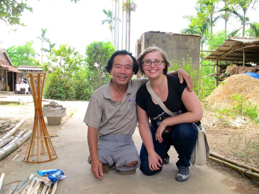 Do Thien Dang and I pose in his front yard. Do lost both of his legs when he stepped on a landmine in 1980. (June 2014)