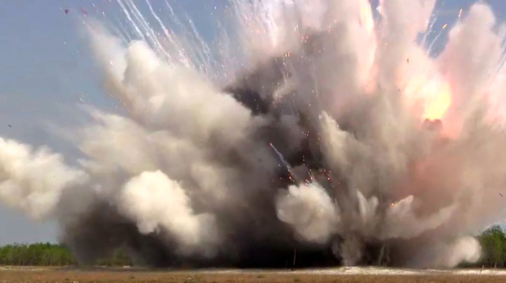 The detonation of the phosphorous bombs releases a cloud of dust and fire. (Photo by Nissa Rhee, June 2014)